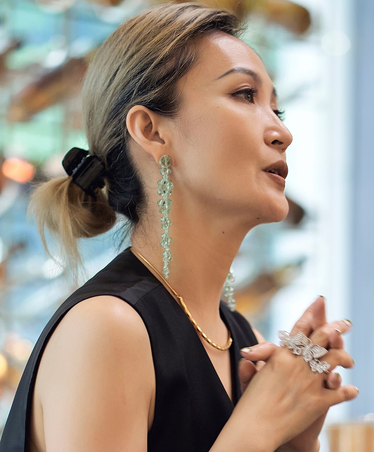 Woman with elegant jewelry in profile view.