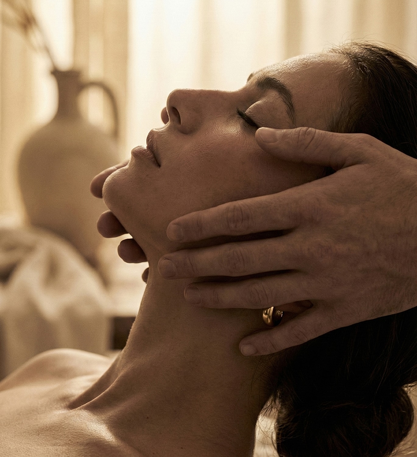 Person receiving a gentle facial massage.