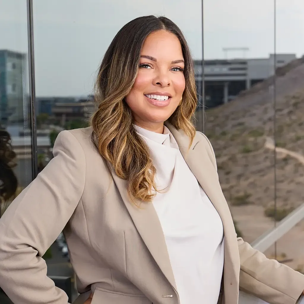 Smiling professional woman in stylish office attire.