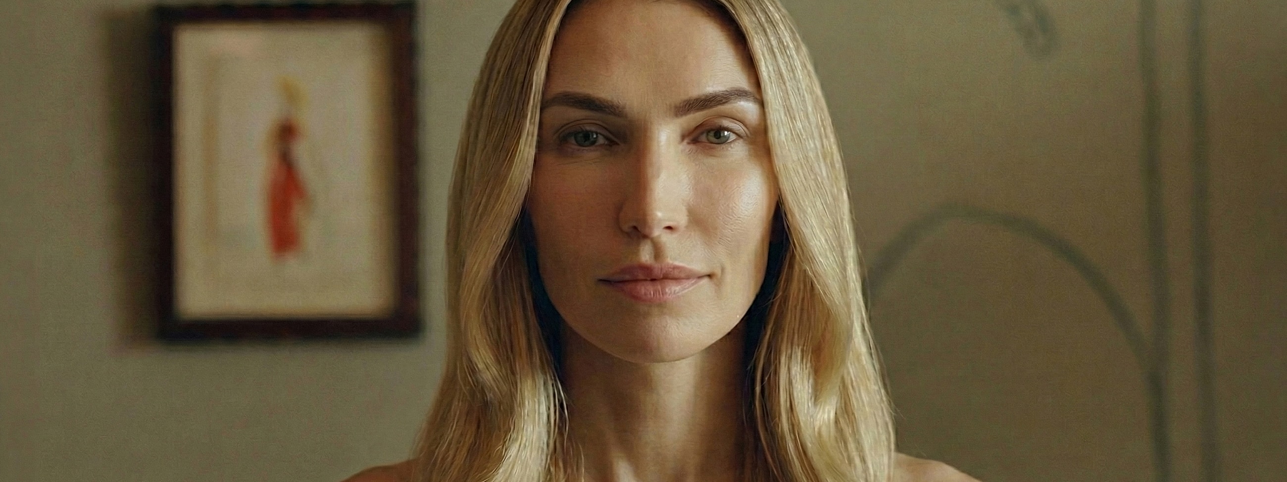 Woman with long hair in a neutral setting.