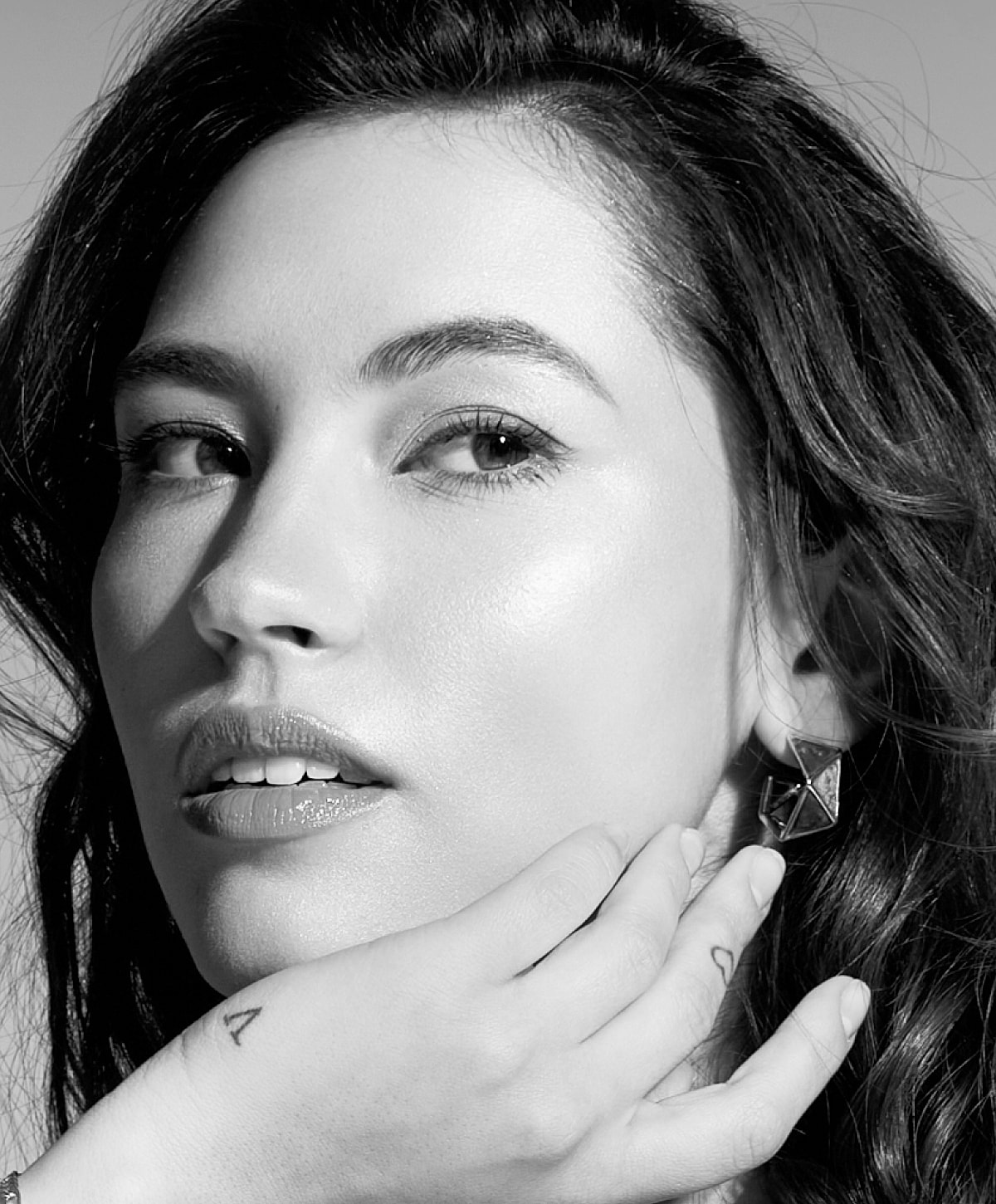 Smiling face in black and white close-up.